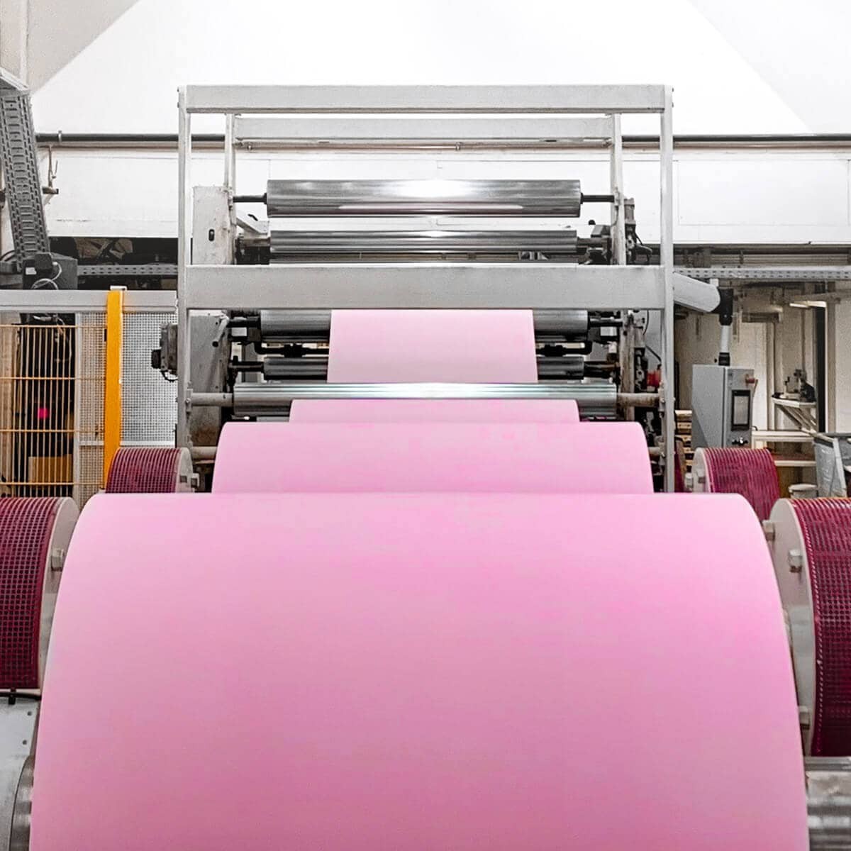 Reel-to-sheet lamination service example: cardboard pink
